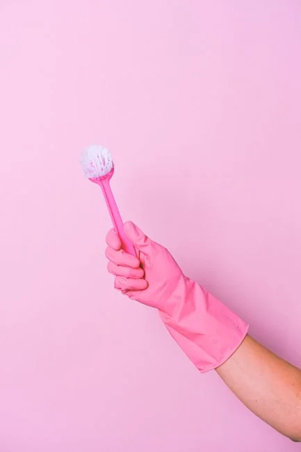 A cheerful couple shares a playful cleaning tussle in their living room, highlighting the lighter side of home life.